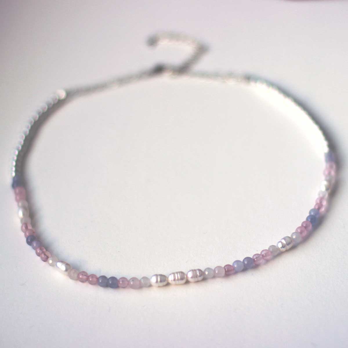 Beaded necklace 4mm in rose quartz, aquamarine, white quartz and pearl beads in a gradient resembling the trans pride flag