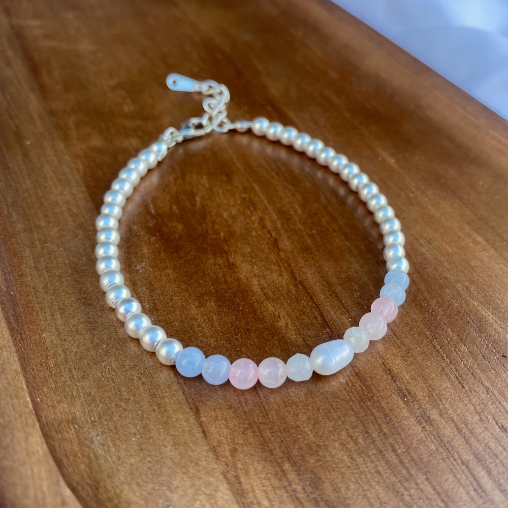 Silvery beaded bracelet with rose quartz, aquamarine, white quartz and peal beads resembling the trans pride flag
