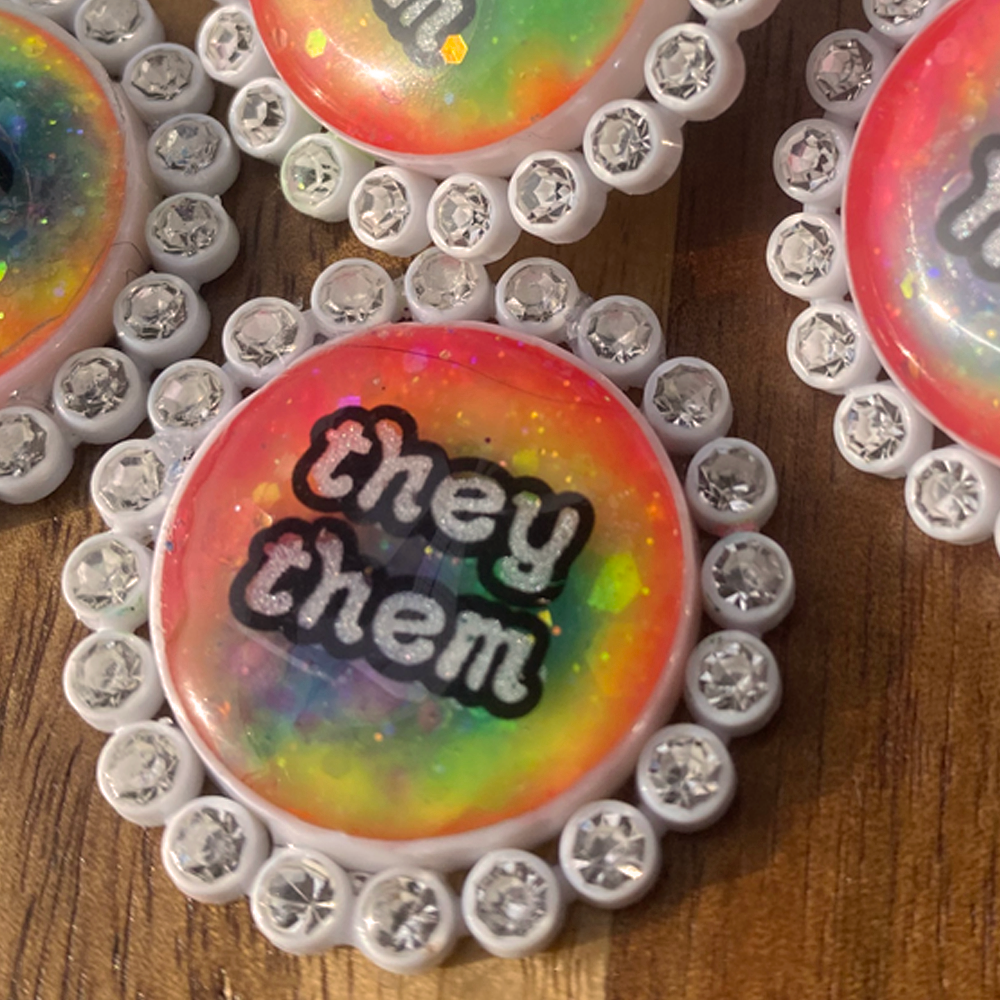 White rhinestone glowing pride pins