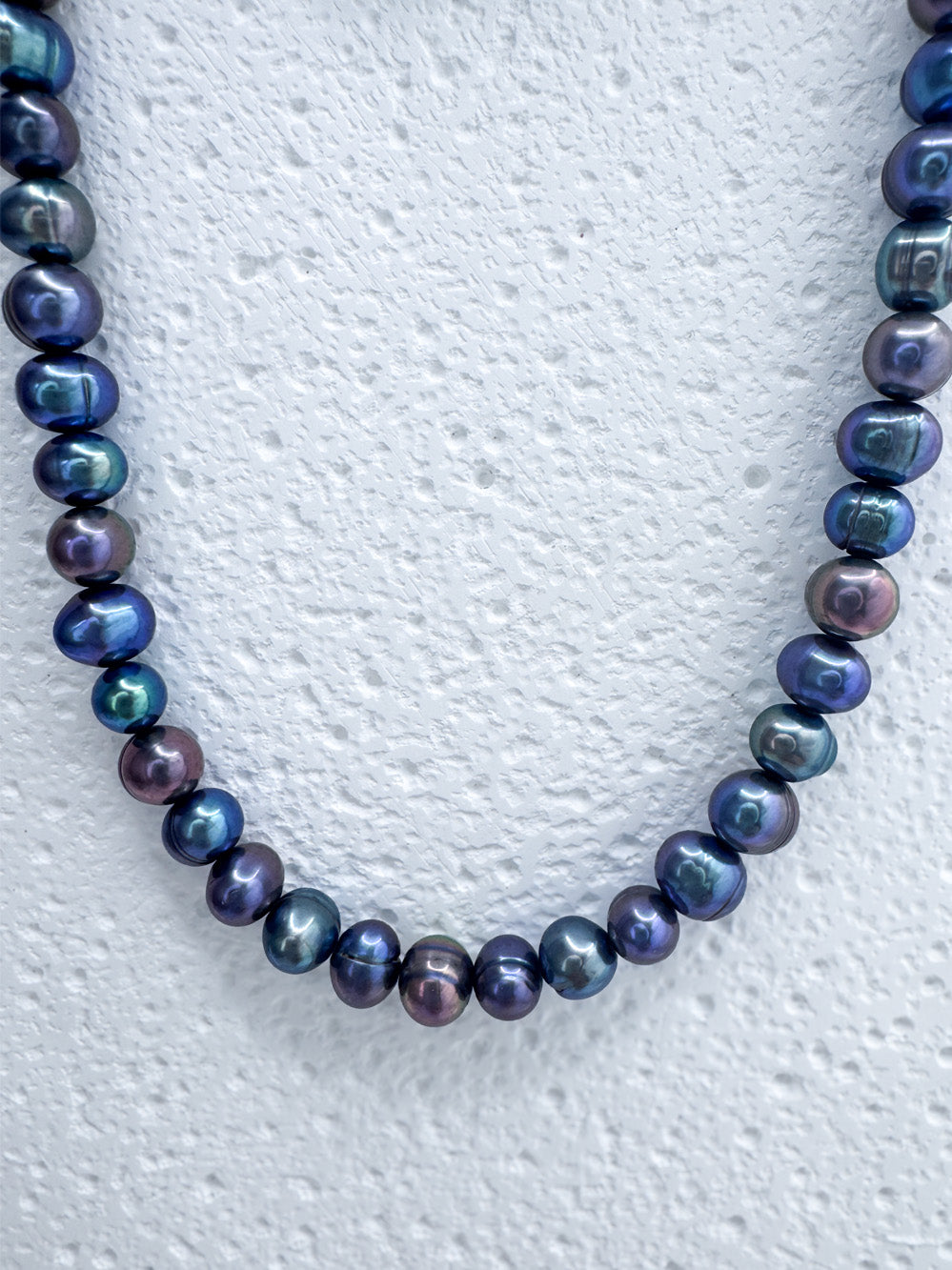 Close up on tahitian-like pearls within iridian's metallic blue pearl and sterling silver fully beaded necklace