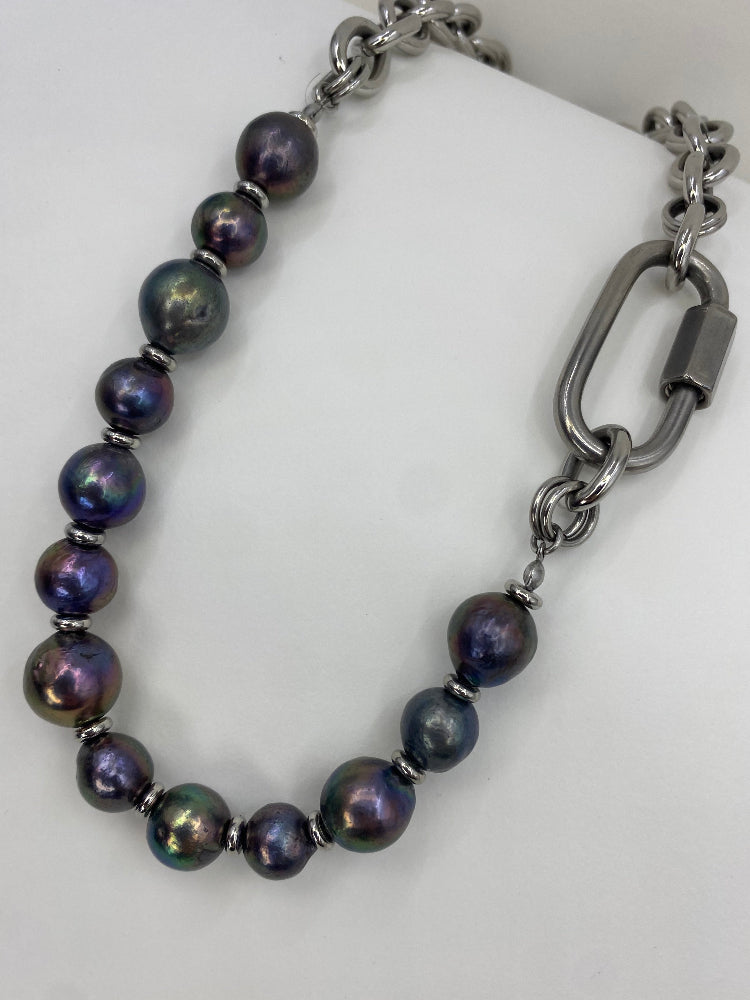 Pearl necklace with a large metal carabiner clasp on a white background