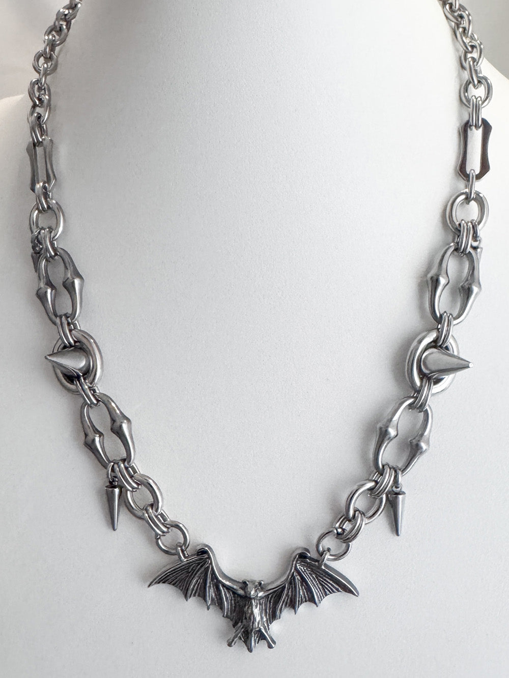 iridian design's stainless steel bat pendant and spike necklace on a white display bust