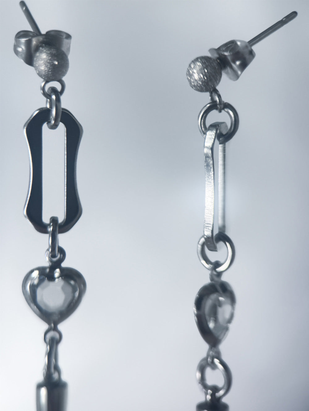 iridian design's crystal heart spiked stud earrings in various settings